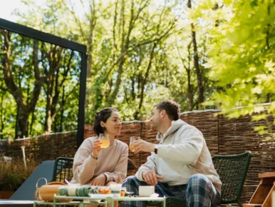 Couple savourant un petit-déjeuner en terrasse au Lodge Miroir, séjour en couple en Vendée
